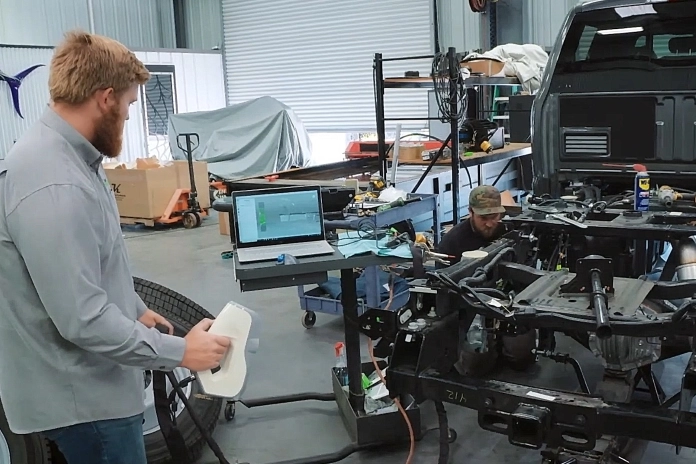 Jack Fisher scanning the rear of Brad DeBerti’s Ford F450 for Ford’s SEMA display with Artec Eva